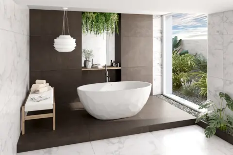 Baignoire îlot moderne dans une salle de bain feng shui, avec des plantes luxuriantes et une vue sur le ciel bleu.