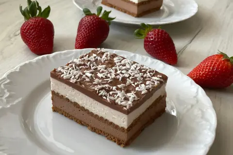Czekoladowo-śmietankowy deser z mascarpone i wiórkami kokosowymi, ozdobiony truskawkami.