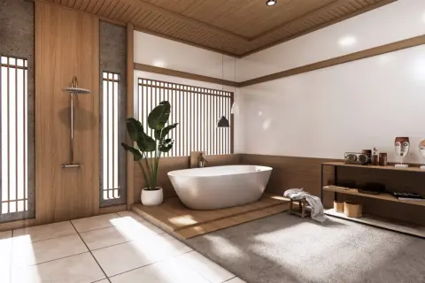 Minimalistyczna łazienka japandi z wolnostojącą wanną, drewnianymi elementami i kamiennymi detalami.