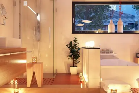 Salle de bain moderne et chaleureuse, baignée de lumière douce. Quel luminaire pour salle de bain choisir pour une ambiance zen ? Bougies et spots discrets créent une atmosphère relaxante.
