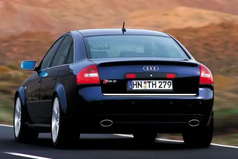 Ciemnoniebieskie Audi RS6 C5 z tablicą rejestracyjną HN TH 279 jedzie po drodze.