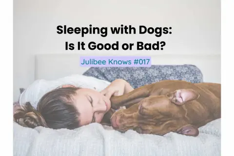 A woman and her dog are sleeping peacefully together in bed. The text "Sleeping with Dogs: Is It Good or Bad?" is overlaid on the image.