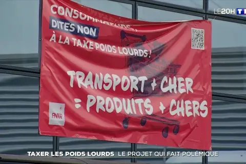Bannière rouge "Consommateurs, dites non à la taxe poids lourds ! Transport + cher = produits + chers". Document sur la taxe à l'essieu.