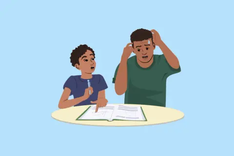 Dos jóvenes estudian un libro, uno señala un gráfico y el otro se rasca la cabeza, confundido por las abreviaturas en inglés.