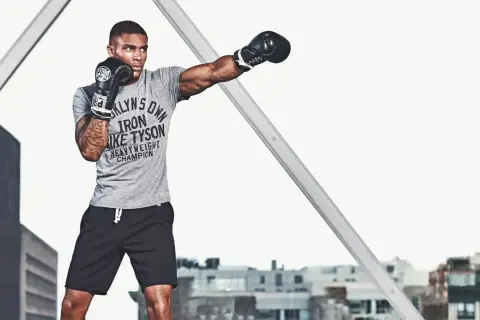 Boxer throws a punch, showcasing the power and benefits of punching with dumbbells for strength and conditioning.