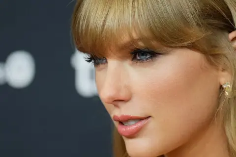 Taylor Swift's profile, with striking blue eyes and blonde bangs, hints at her latest Spotify release.