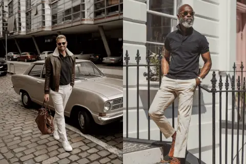 Zwei Männer in lässiger Kleidung. Links ein Mann mit brauner Lederjacke und schwarzem Polohemd, daneben ein Oldtimer. Rechts ein Mann in schwarzem Polohemd und beiger Hose.