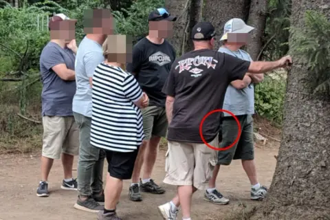 Undercover cops at festivals blend in with the crowd. One officer's concealed firearm is visible in a red circle.