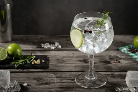 Orzeźwiający gin z tonikiem i plasterkiem cytryny, ozdobiony gałązką rozmarynu. Idealny na letnie wieczory.