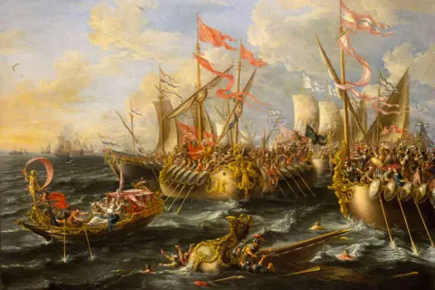 La batalla de Accio en pleno apogeo. Galeras y naves de guerra se enfrentan en un mar agitado, con soldados y remos en acción.
