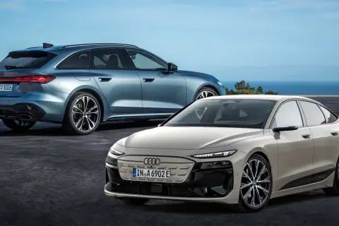 Due eleganti audi modelli, una station wagon blu e una berlina beige, si stagliano contro un cielo azzurro e il mare.
