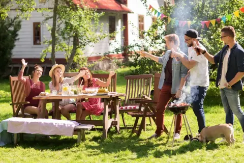 Vänner njuter av grillfest och lekar, sommarens roligaste fester. En liten gris kikar fram.