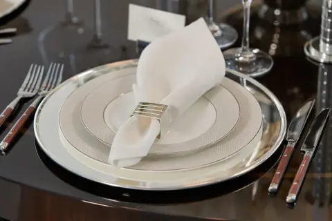 Elegant dukning med flera tallrikar. Frågan "hur många tallrikar ska man ha" besvaras med en lyxig uppsättning.
