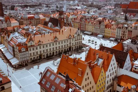 Widok z góry na Rynek we Wrocławiu z kolorowymi kamienicami i ratuszem.