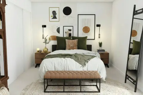 Habitación pequeña con cama grande, decorada con arte abstracto y cojines verdes. Un banco de terciopelo marrón al pie de la cama.