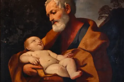 Św. Józef, opiekun rodziny, czule trzyma Dzieciątko Jezus. Obraz przypomina o modlitwie litanii do św. Józefa.
