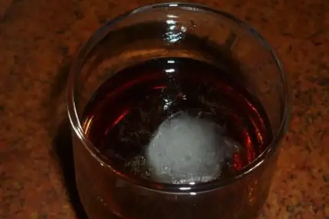Szklanka z bursztynowym trunkiem i kostką lodu. Czekam na ten wyjątkowy metaxa smak.