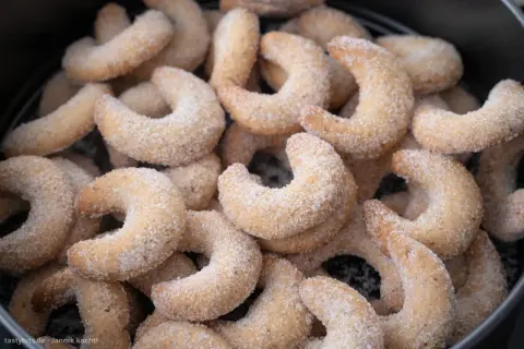 Ein Haufen zarter Vanillekipferl, bestreut mit feinem Zucker, wartet darauf, genossen zu werden.