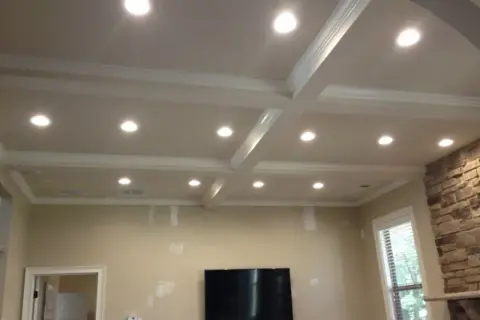 A coffered ceiling with recessed lighting, questioning if recessed lighting is out of style.