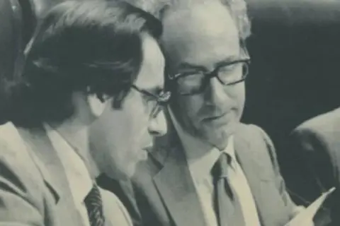 Miguel Boyer y Salvador looking at documents.