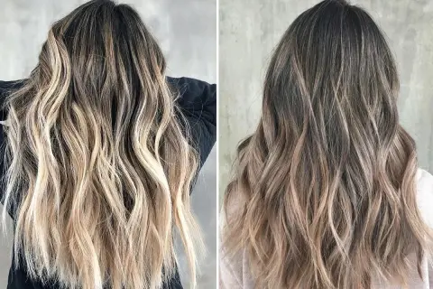 Długie, falowane włosy z efektem flamboyage, przechodzące od ciemnego brązu do jasnego blondu.