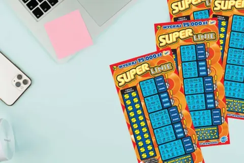 Trzy zdrapki Super Linie leżą obok telefonu i słuchawek. Dowiedz się, jak odczytać zdrapkę Super Linie, aby wygrać 75 000 zł!