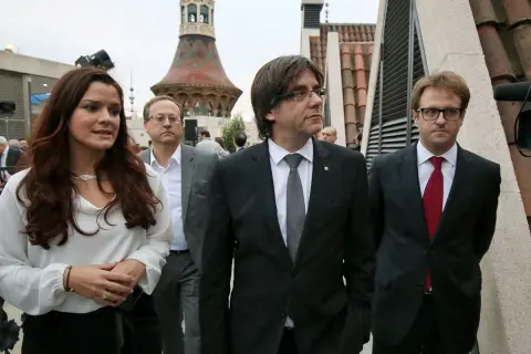 Francisco Javier Puig, con traje oscuro y corbata gris, camina junto a otros políticos.