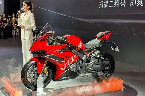 Presentación de la Voge 666 RR, una motocicleta deportiva roja brillante con una presentadora en un traje blanco.