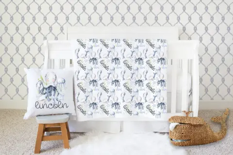 Nautical nursery with under the sea crib bedding sets featuring octopuses, narwhals, and jellyfish. A whale basket sits nearby.