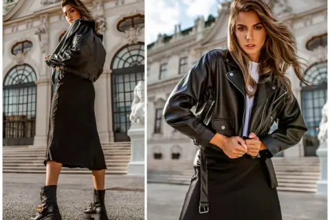 Elegancka kobieta w czarnej ramonesce i spódnicy. Dowiedz się, jak prać czarne ubrania, by zachowały swój kolor.