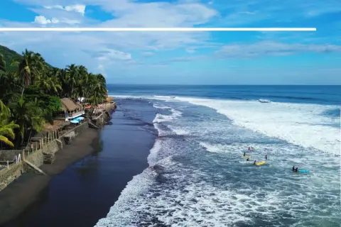 Surfer genießen die Wellen an der Küste El Salvadors. Ein Paradies für Backpacking und Wassersport.