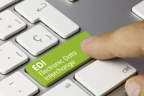 Palec naciska zielony klawisz z napisem EDI Electronic Data Interchange. To skrót od Electronic Data Interchange, czyli elektronicznej wymiany danych.