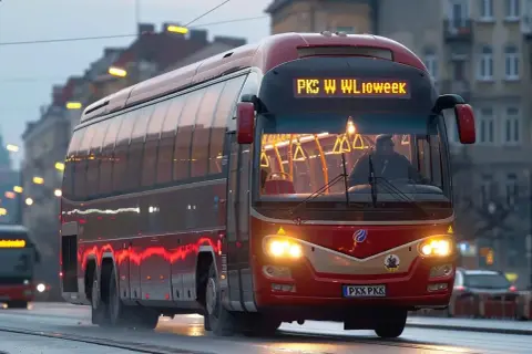 Czerwony autobus PKS jedzie ulicą. Zastanawiasz się, jaka jest pks bilet miesięczny cena?