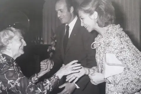 Dolores Rivas Cherif sonríe al saludar al rey Juan Carlos I y a la reina Sofía.
