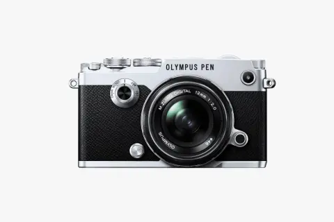 The Olympus PEN-F camera, a stylish blend of retro design and modern technology, ready to capture your next masterpiece.