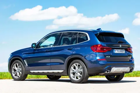 Niebieskie BMW X3 na tle błękitnego nieba. Sprawdź dane techniczne tego SUV-a.