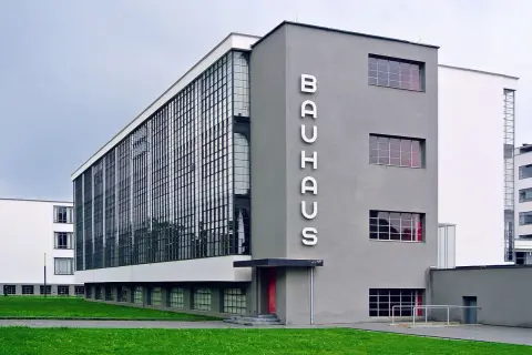 Iconic Bauhaus architecture examples: the Dessau building with its glass curtain wall and prominent "BAUHAUS" lettering.