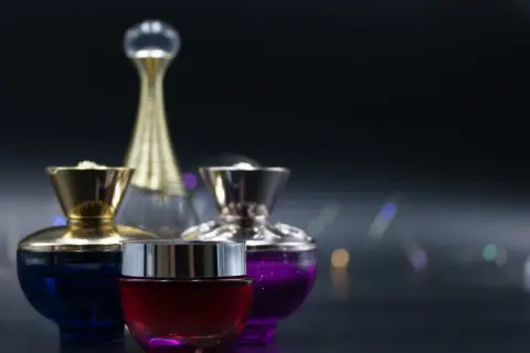 Eleganckie, damskie perfumy arabskie w ozdobnych flakonach: czerwony, niebieski i fioletowy.