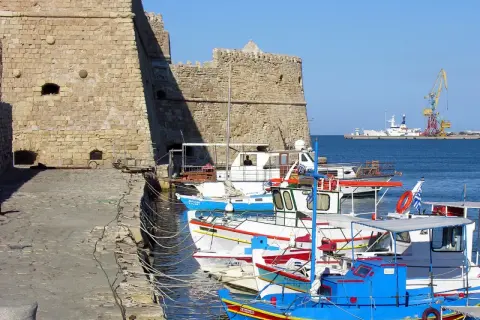Port w Heraklionie, Kreta. Wrzesień, idealna temperatura na rejs. W tle twierdza, łodzie rybackie i dźwig portowy.
