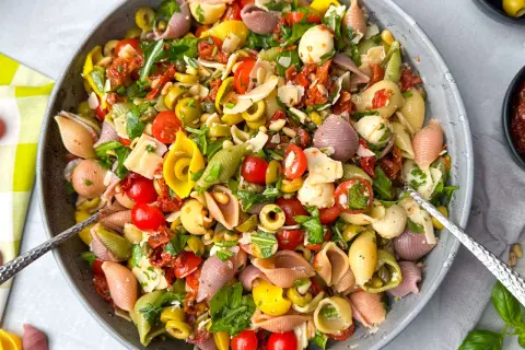 Bunter Nudelsalat mit Mozzarella, Tomaten, Oliven und getrockneten Tomaten – perfekte Beilagen für Grillen Ideen.