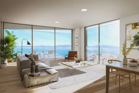 Un ático moderno con vistas al mar. Ideas para decorar un ático: sofá, mesa de centro, plantas y arte.