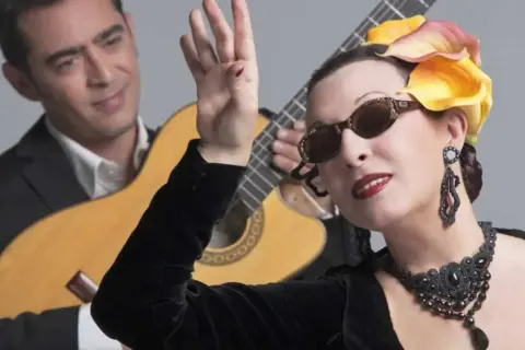 Martirio, icónica en los años 80, con su estilo inconfundible, posa con un guitarrista.
