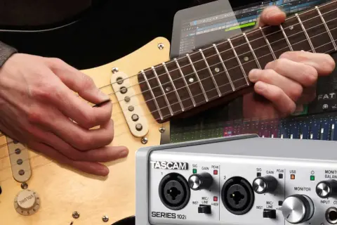 Gitarre aufnehmen PC: Hände spielen Gitarre, daneben ein Audio-Interface und eine DAW-Oberfläche.