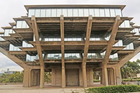 The Geisel Library, a famous brutalist architecture masterpiece, features stacked concrete levels with glass windows, resembling a Mayan pyramid.