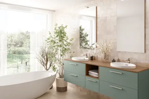 Élégante salle de bain verte et beige avec baignoire îlot, double vasque et plantes luxuriantes.
