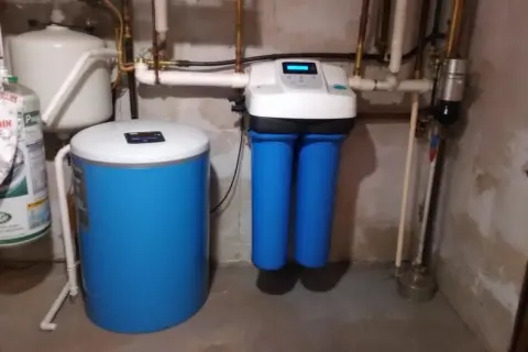 Système de filtration d'eau avec adoucisseur bleu et deux cartouches bleues, optimisant la consommation d'eau adoucie.