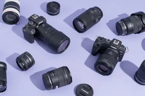 A collection of Canon EOS R cameras and various best L series lenses, including zooms and primes, are artfully arranged on a lavender background.
