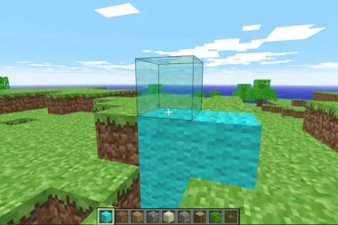 Gra w **minecraft w przeglądarce**. Gracz buduje wieżę z niebieskich bloków, na której stawia szklaną ścianę.