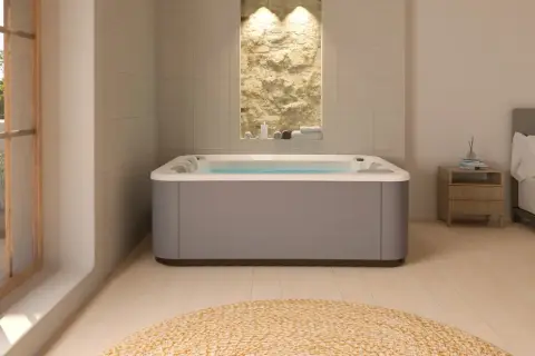 Nowoczesne jacuzzi w łazience z kamienną ścianą i widokiem na balkon.