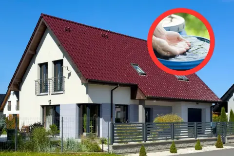 Nowy dom z czerwonym dachem i systemem zbierania deszczówki. Dofinansowanie do deszczówki ułatwia oszczędzanie wody.